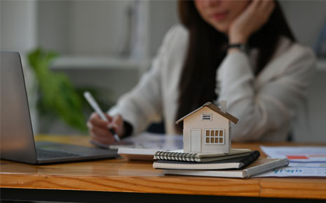 A picture of a real estate agent looking over housing information at the office.
